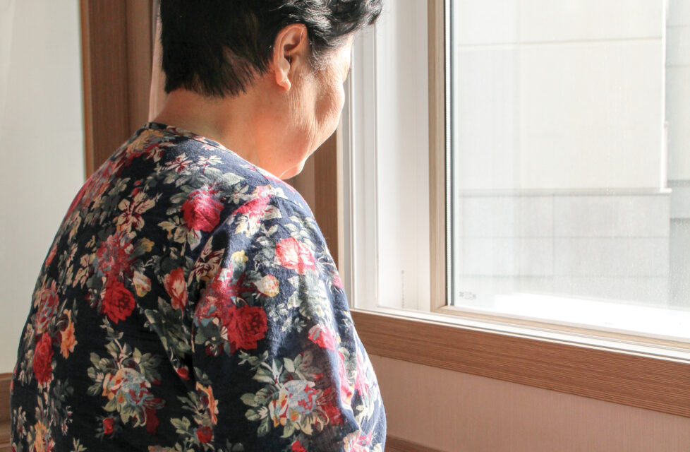 North Korean Defector Finds Christ In China An elderly woman sits by a window