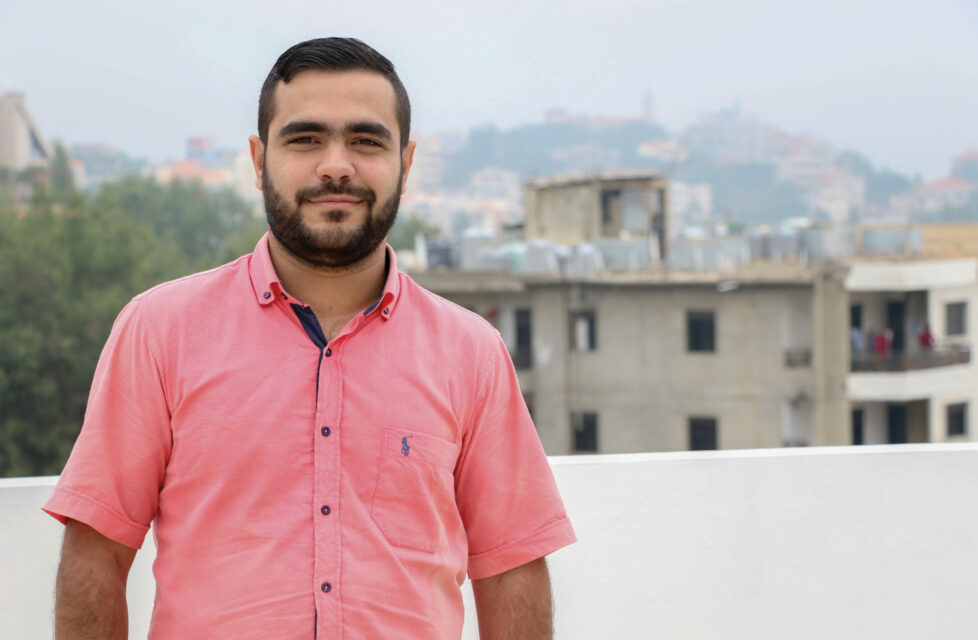 middle east man smiles at camera