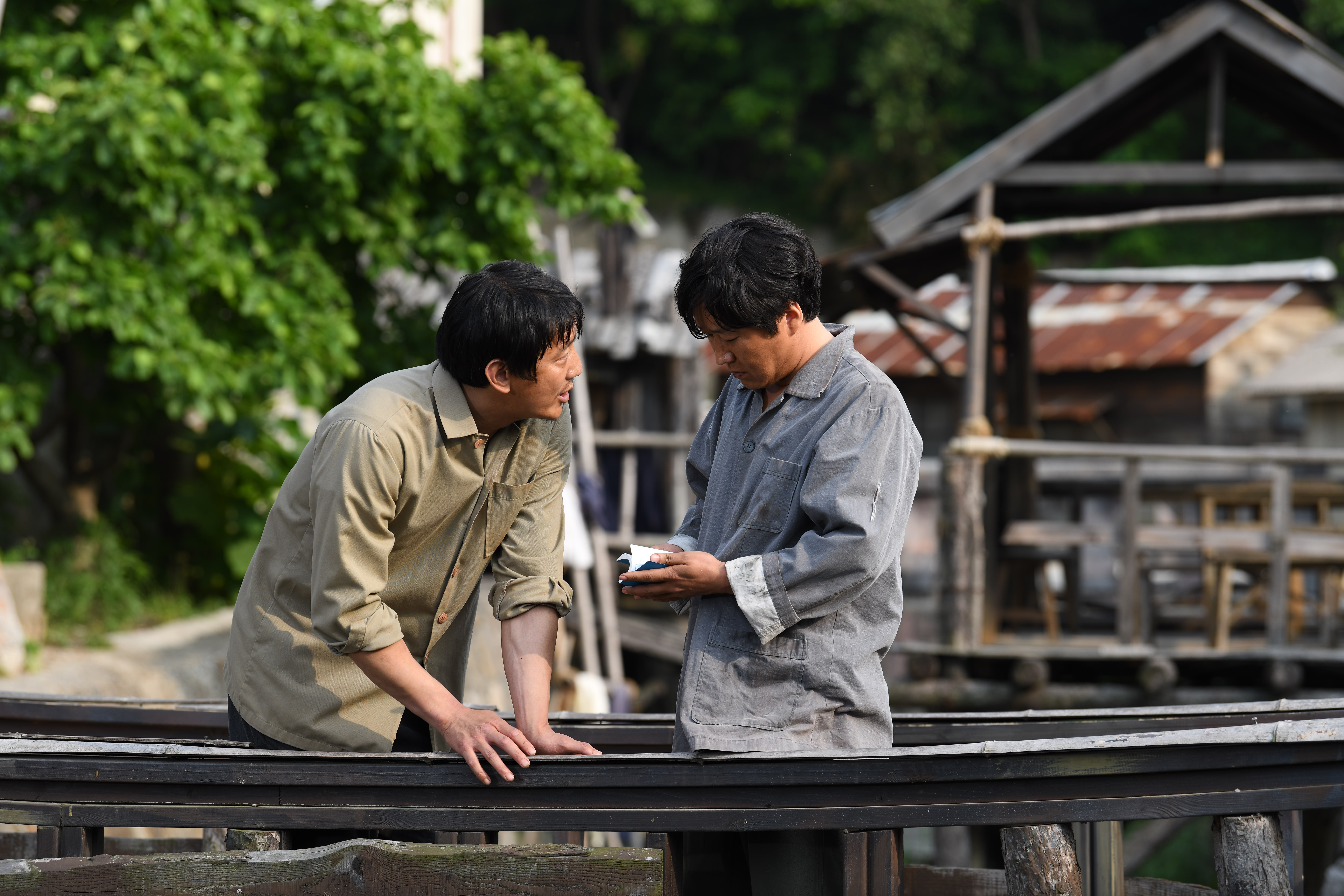 Network of North Korean Believers Lead Over 700 to Christ One man with Bible standing with another man