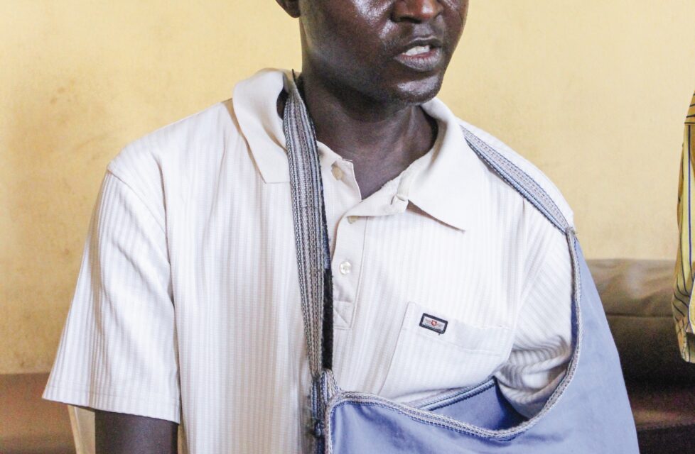 Nigerian Couple Attacked by Muslims; Wife, Mother of Five Killed a man sits in a chair with his arm in a sling