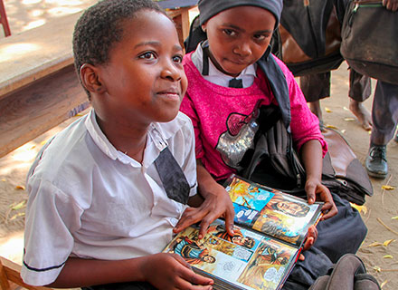 Boy and girl reading book